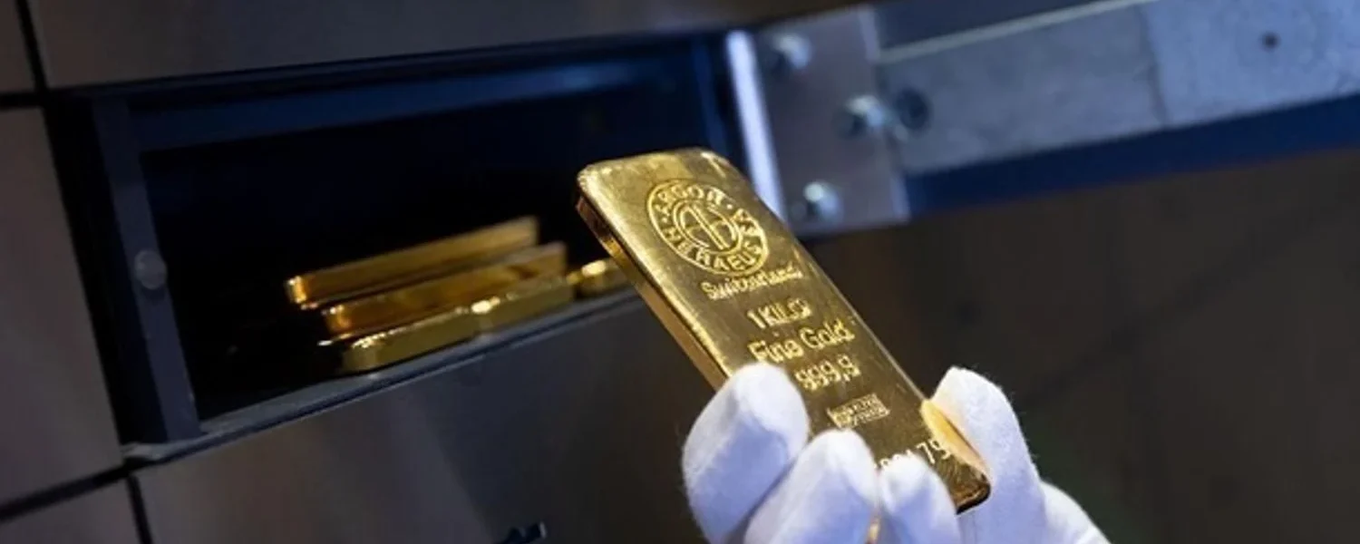 Світові ціни на золото знизилися через зміцнення долара та низьку активність на азійських ринках